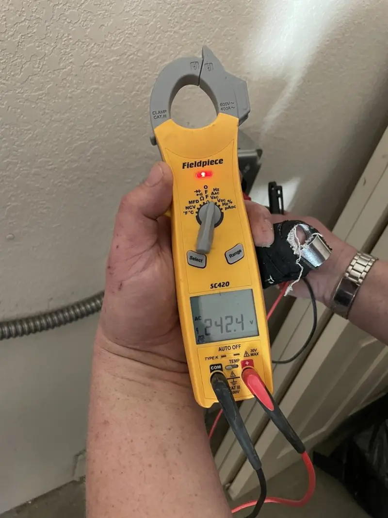 Voltage testing with clamp meter during Outlet Installation in North Tonawanda